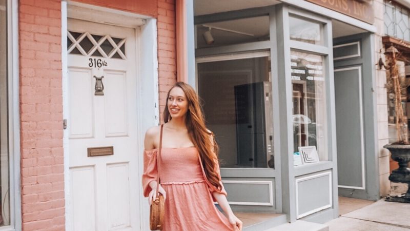 Girl with pink dress discussing creativity.